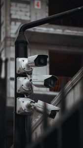 Array of security cameras on a building post, highlighting surveillance and urban security.