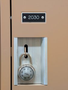 Close-up of a school locker with a secure combination padlock for safety and privacy.