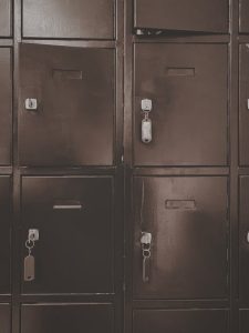 A close-up of vintage metal lockers with padlocks in a sepia tone, capturing a classic security theme.
